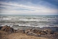 Sunset at the sea shore of a beach with rocks and stormy waves, beautiful seascape at Caspian sea Absheron, Azerbaijan Novkhani Royalty Free Stock Photo