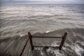 Sunset at the sea shore of a beach with rocks and stormy waves, beautiful seascape at Caspian sea Absheron, Azerbaijan Novkhani Royalty Free Stock Photo