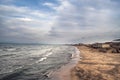 Sunset at the sea shore of a beach with rocks and stormy waves, beautiful seascape at Caspian sea Absheron, Azerbaijan Novkhani