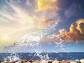 Sunset sea and sea stones on horizon blue yellow fluffy clouds and on front water wave splash nature landscape summer travellin