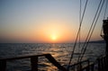 Sunset in the sea, sunset on the horizon, wooden railing of a pleasure sailboat.