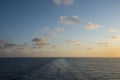 Sunset on the sea with wake of the ship