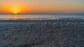 Sunset in Sealine with beautiful sand pattern emerged due to low tide Royalty Free Stock Photo