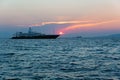 Sunset seascape with huge ship near Mykonos, Greece