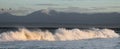 Sunset Seascape. Powerful ocean wave on the surface of the ocean. Wave breaks on a shallow bank. Stormy weather, stormy clouds sky