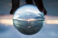 Seascape Sunset Captured in Small Glass Ball with Boat on Horizon Royalty Free Stock Photo