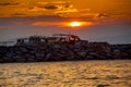 Sunset on the seashore. Moored fishing boats in the rays of the setting sun Royalty Free Stock Photo