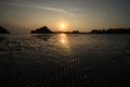 Sunset at the seaside in a low tide when bottom of the sea is visible