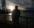 Man watching sunset in Seattle Washington overlooking The Great Wheel Royalty Free Stock Photo