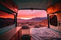 Sunset seen from back of camper van with mountains and desert landscape. Concept of nature and having freedom in holiday
