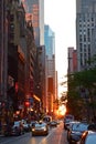 Sunset seen from a street with tall buildings & beautiful reflection in New York City concrete jungle