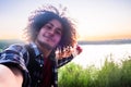 Sunset Selfie: Cheerful Arabian Hiker Captures Lakeside Joy