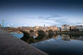 Sunset sene of St. Angelo Bridge over River Tiber in Rome, italy under gray dramatic sky Royalty Free Stock Photo