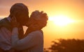 Sunset, senior couple and kiss outdoor, care or bonding together for connection in marriage. Man, woman or touch lips Royalty Free Stock Photo