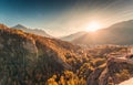 Sunset shines over Briancon town with autumn forest and waterfall in Hautes Alpes, France Royalty Free Stock Photo