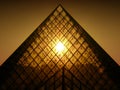 Sunset shining through Louvres pyramid