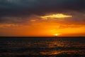 sunset and ship on horizontal ocean water surface colorful cloud Royalty Free Stock Photo