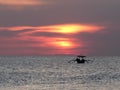 Sunset shot of a fishing boat at kuta beach on bali Royalty Free Stock Photo