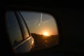 Sunset in the side mirror, darkness in road traffic