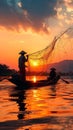 Sunset silhouette Asian fisherman on a wooden boat casts nets