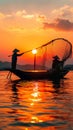 Sunset silhouette Asian fisherman on a wooden boat casts nets