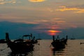 Sunset silhouette of boats in sea Railey bay in Thailand