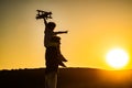 Sunset silhouette of child and dad playing. Kid pilot aviator and daddy dreams of traveling. Happy boy child.