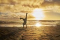 Sunset, silhouette and child doing cartwheel at the beach having fun, playing and enjoy nature. Freedom, inspiration for Royalty Free Stock Photo