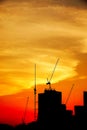 Sunset silhouette construction building tower crane cross on the roof of the church of the Sloane Royalty Free Stock Photo