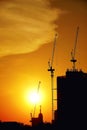 Sunset silhouette construction building tower crane cross on the roof of the church of the Sloane Royalty Free Stock Photo