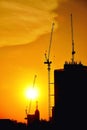 Sunset silhouette construction building tower crane cross on the roof of the church of the Sloane Royalty Free Stock Photo