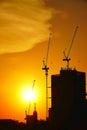 Sunset silhouette construction building tower crane cross on the roof of the church of the Sloane Royalty Free Stock Photo