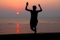 Sunset and silhouette of a dancer in the beach Royalty Free Stock Photo