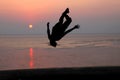 Sunset and silhouette of a dancer in the beach Royalty Free Stock Photo