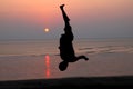 Sunset and silhouette of a dancer in the beach Royalty Free Stock Photo