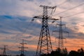 Sunset with a silhouette of electricity pylon and power lines Royalty Free Stock Photo