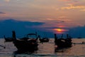 Sunset silhouette of fishing boat on sea beach in Thailand Royalty Free Stock Photo