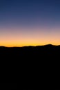 Sunset silhouette hills on the horizon in a summer day