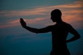 Sunset silhouette of man practicing martial arts