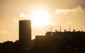 Sunset silhouette of an oil tank and other indusrial buildings Royalty Free Stock Photo