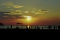 Sunset silhouette of people playing at the beach Royalty Free Stock Photo