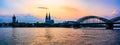 Sunset silhouette skyline landscape of the gothic Cologne Cathedra, Hohenzollern railway and pedestrian bridge, the old town and Royalty Free Stock Photo