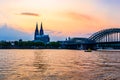 Sunset silhouette skyline landscape of the gothic Cologne Cathedra, Hohenzollern railway and pedestrian bridge, the old town and Royalty Free Stock Photo