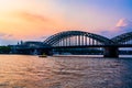 Sunset silhouette skyline landscape of the gothic Cologne Cathedra, Hohenzollern railway and pedestrian bridge, the old town and Royalty Free Stock Photo