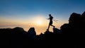 Sunset silhouette of skyrunner man descending from alpine ridge with poles Royalty Free Stock Photo