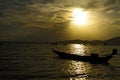 Sunset silhouette with small boat on beach Royalty Free Stock Photo