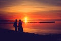 Sunset silhouette of a wedding couple on the beach Royalty Free Stock Photo