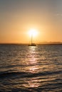 Sunset with a silhouetted boat sailing Royalty Free Stock Photo