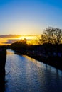 Sunset Silhouettes Along a Riverside Royalty Free Stock Photo