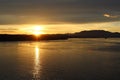 Sunset silhouettes Canadian islands and sun glittering off the water